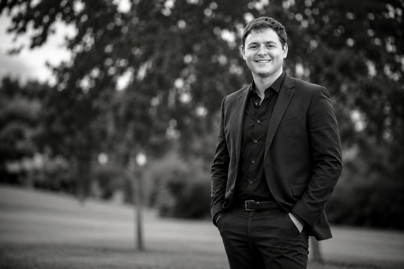 Brian, founder of With This Ring, smiling outdoors in a dark jacket