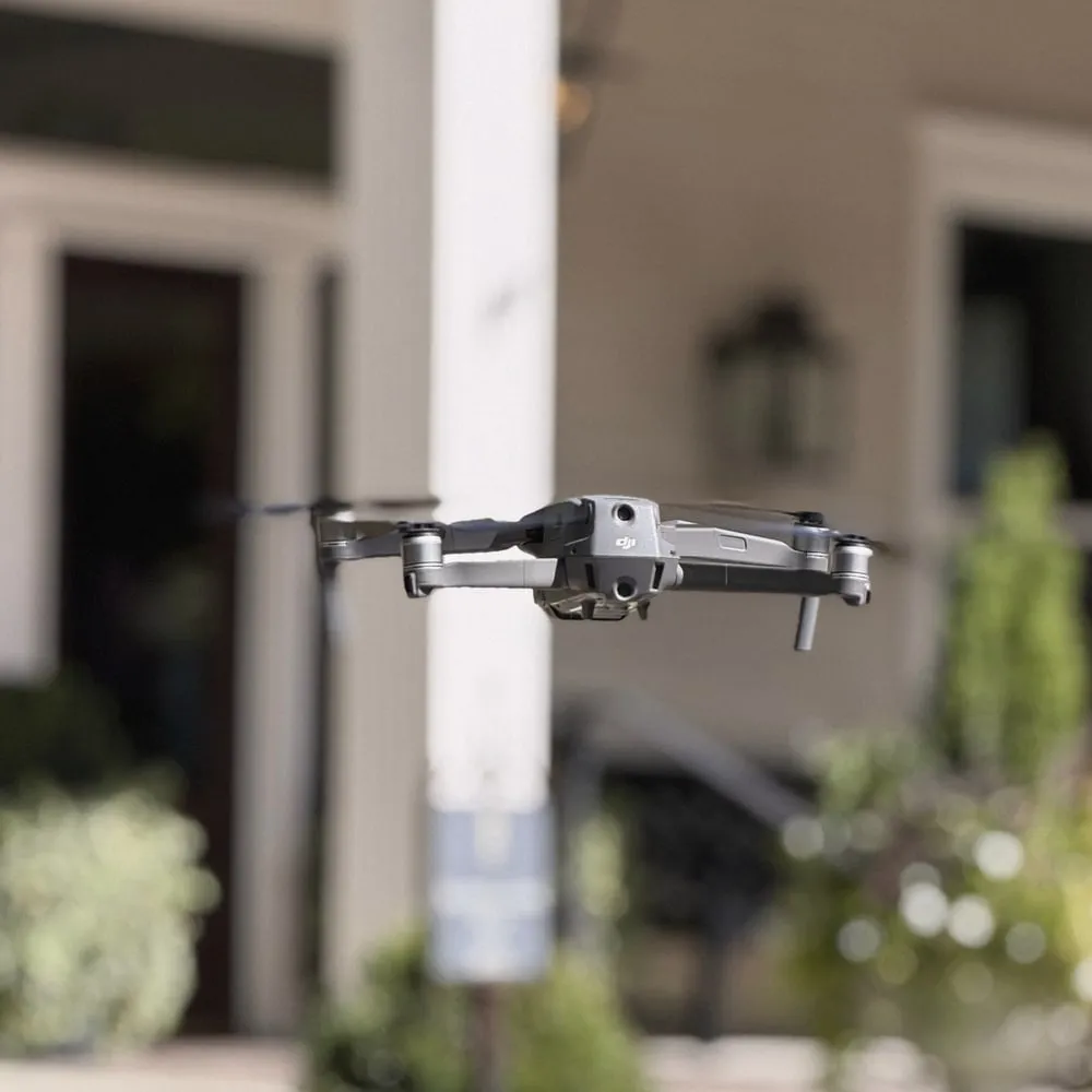 Our drone hovering in front of a wedding venue's porch, lanterns and white flowers soft in the background