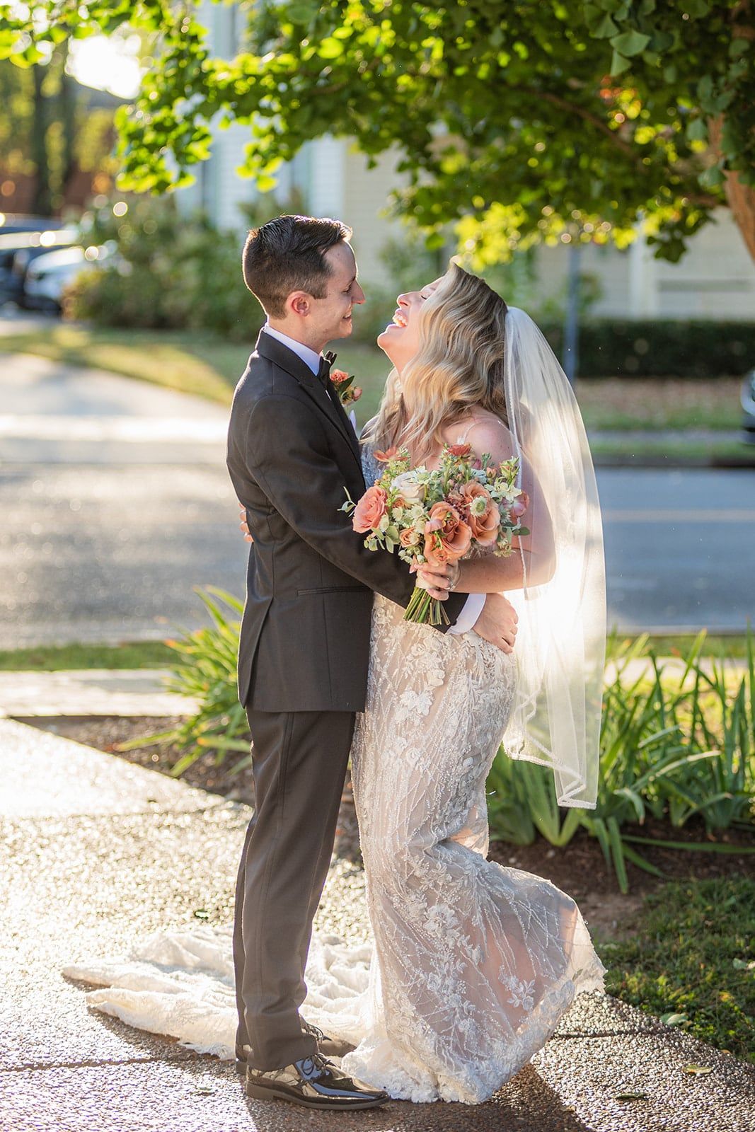 Caitlin and Gunnar laugh together on a tree-lined Franklin street in late afternoon light