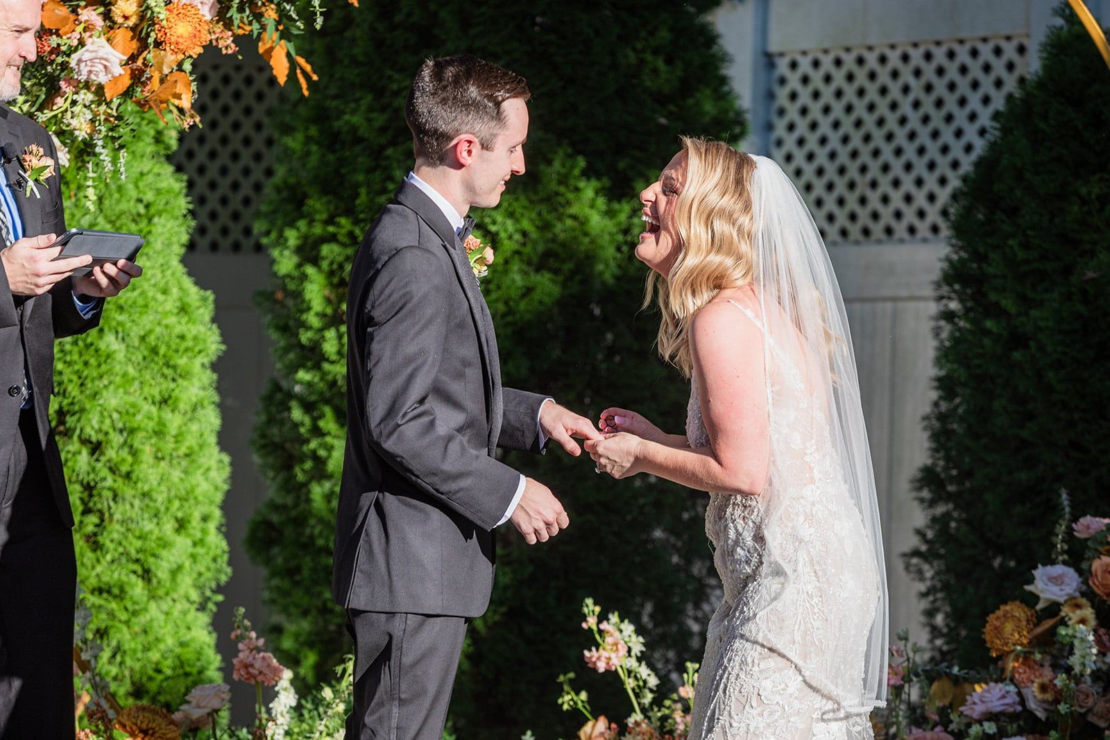 Caitlin and Gunnar hold hands and laugh during their vows