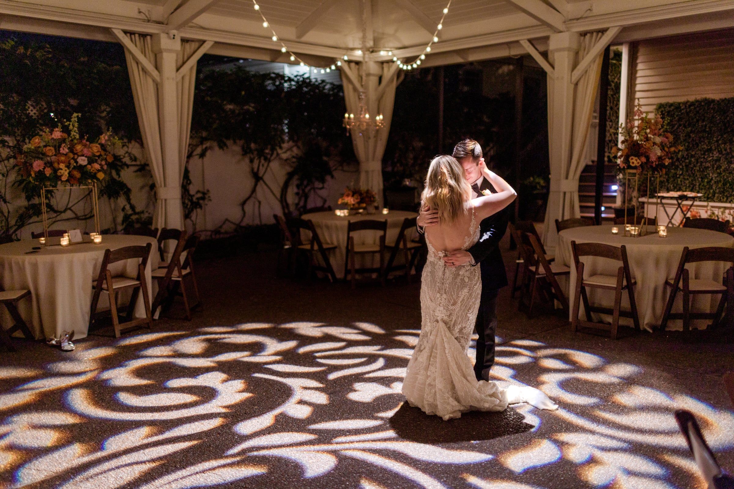 Caitlin and Gunnar's first dance under the tent, patterned light across the floor