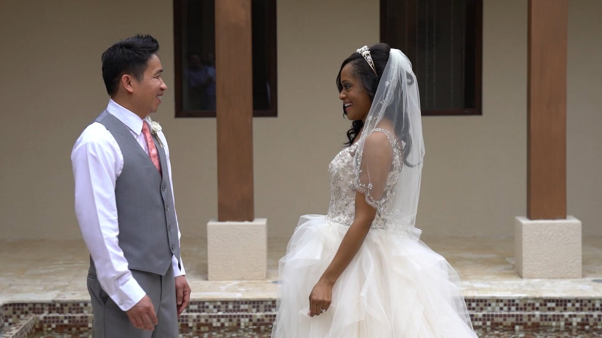 Jillian and Seth smiling at each other in a courtyard at Dreams Las Mareas in Guanacaste, Costa Rica