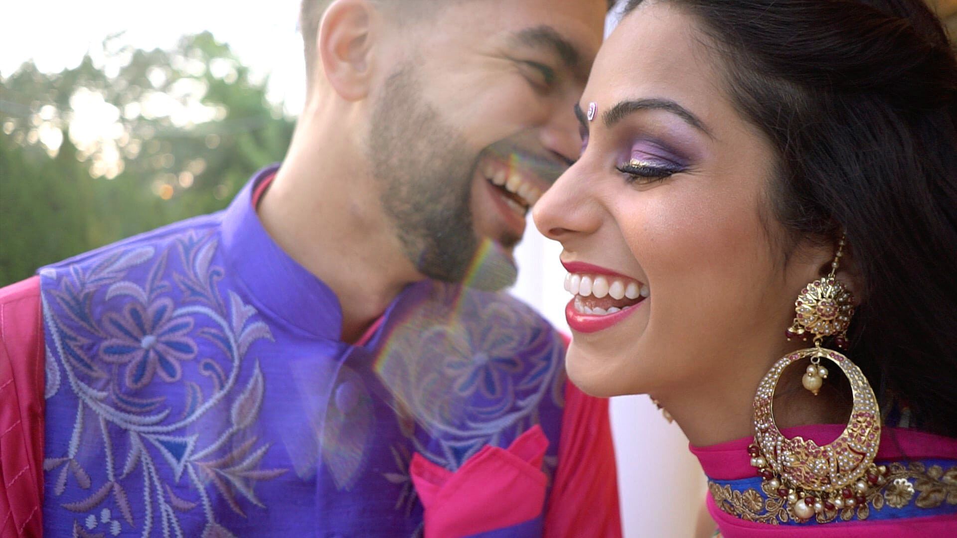 Nadiya, in a purple-edged lehenga and gold earrings, laughs with Sherief, cheek to cheek