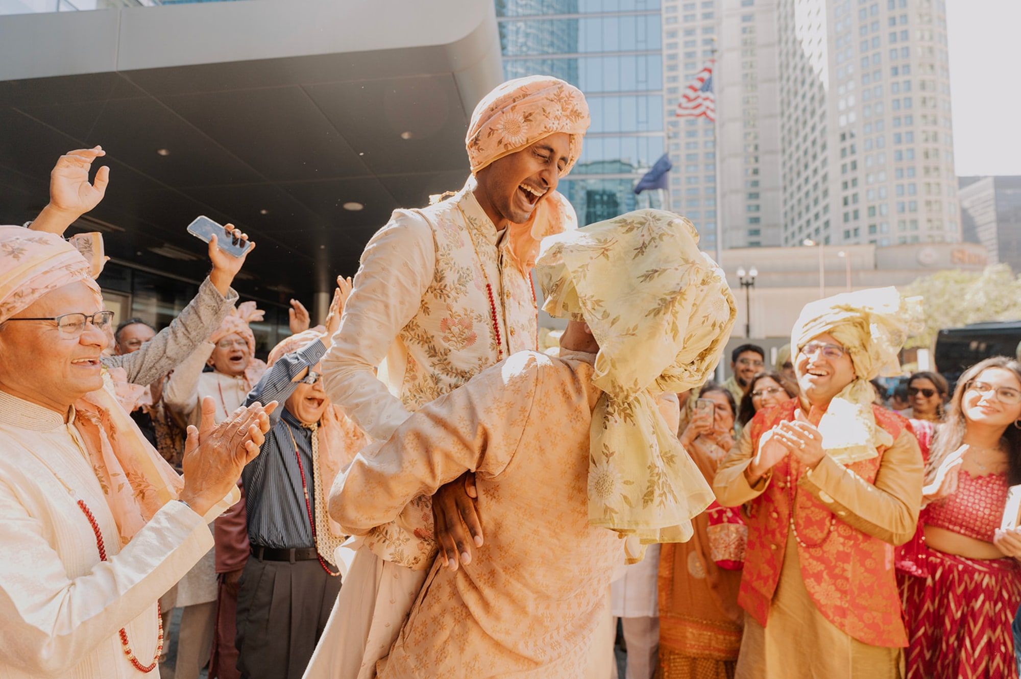 Groom lifted high by his brother as relatives cheer outside a city high-rise
