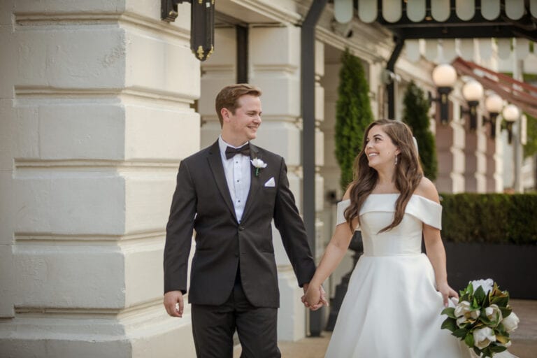 bride and groom walking holding hands in downtown Nashville, TN