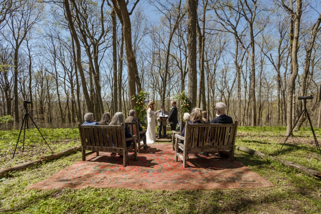 A wide angle of Mamie and Will's hilltop wedding ceremony in Nashville with video cameras from With This Ring Wedding Films on the sidelines.