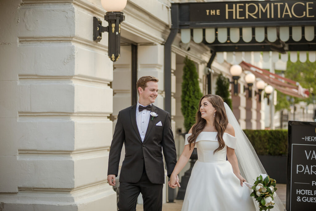 bride Shelby and groom Reid walk holding hands after their wedding ceremony at The Hermitage Hotel in Nashville