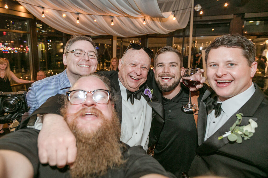 our photo and video team, posed with the groom and his dad at popular Nashville wedding venue Yje Bridge Building