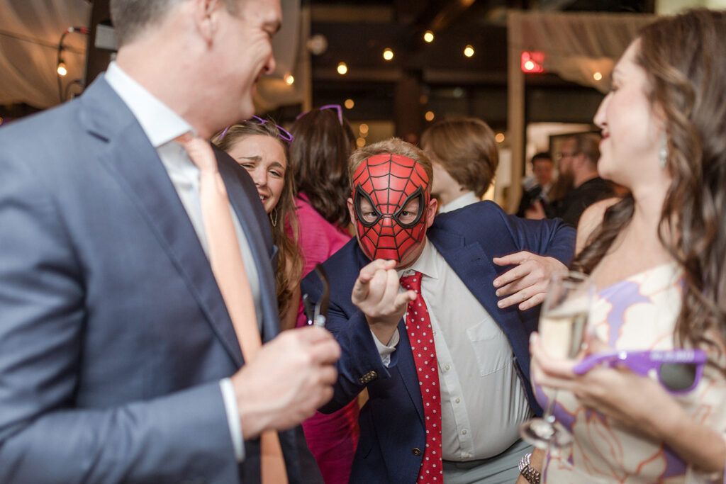 A guests wears a Spiderman mask from the photobooth, captured by Nashville wedding Photographer Micah