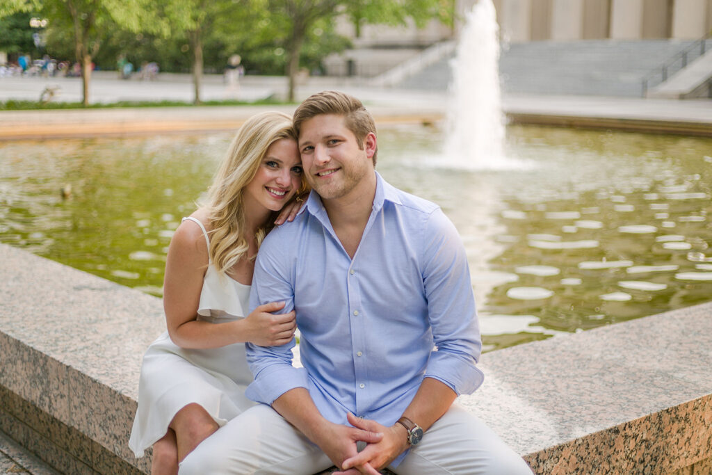 Couple sitting on front of The Parthenon at Centennial Park in Nashville, a top 10 spot for engagement wedding photo shoots.