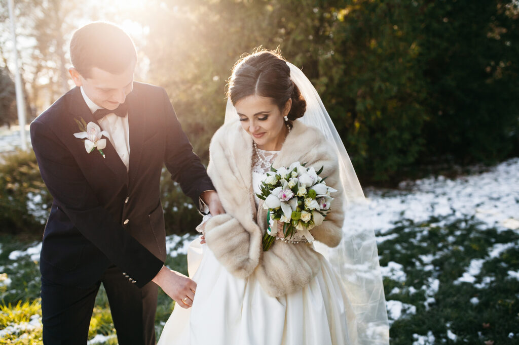 A beautiful bride and groom walk through the Nashville hills with their affordable videographer.