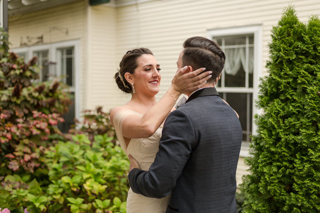 A touching first look moment between bride Kathleen and groom David in front of a lovely historic home in Franklin, TN.