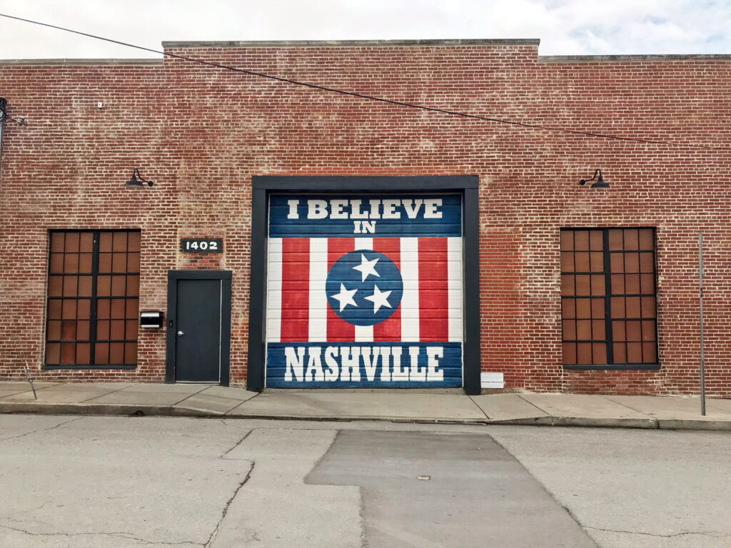 Bride and bridesmaids love posing in front of the “I Believe in Nashville” mural—an iconic photo op during their bachelorette trip to this popular city destination.