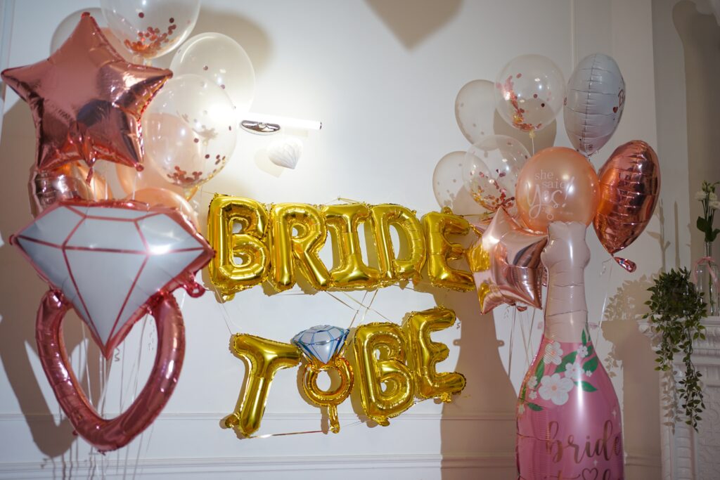Gold “Bride to Be” balloon banner with rose gold and clear confetti balloons, diamond ring and champagne bottle decor—perfect for a Nashville bachelorette party setup or bridal shower celebration.